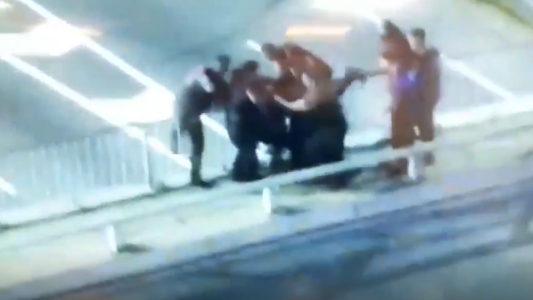 La maniobra de un grupo de policías para salvar a una joven que quería arrojarse de un puente