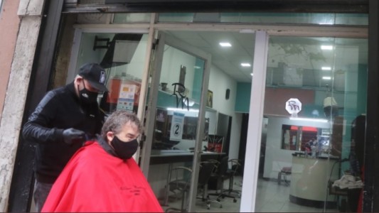 "No es rebeldía, necesito trabajar": peluquero atiende en la vereda