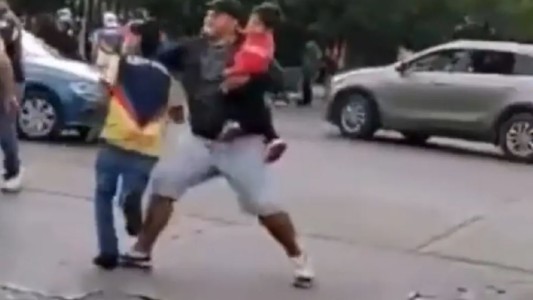 Lamentable: hincha se agarra a las piñas con su hijo en brazos